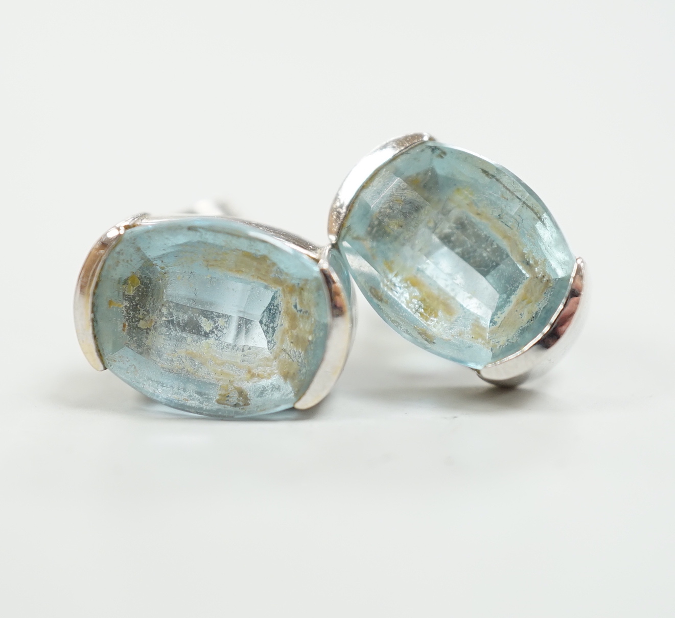 A modern pair of 750 white metal and single stone blue topaz set ear studs, length 13mm, gross weight 5.6 grams.